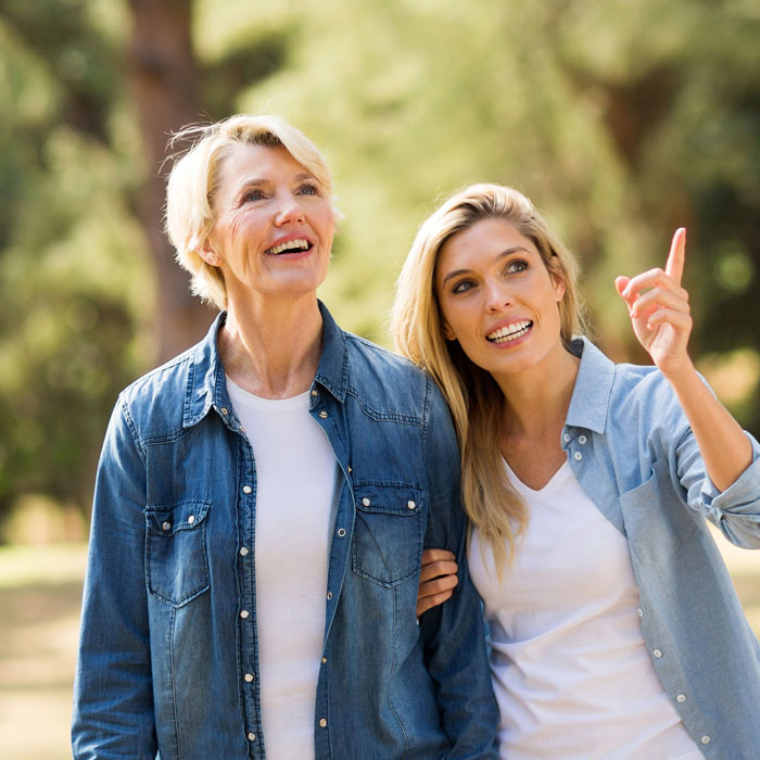 two people smiling, and one pointing